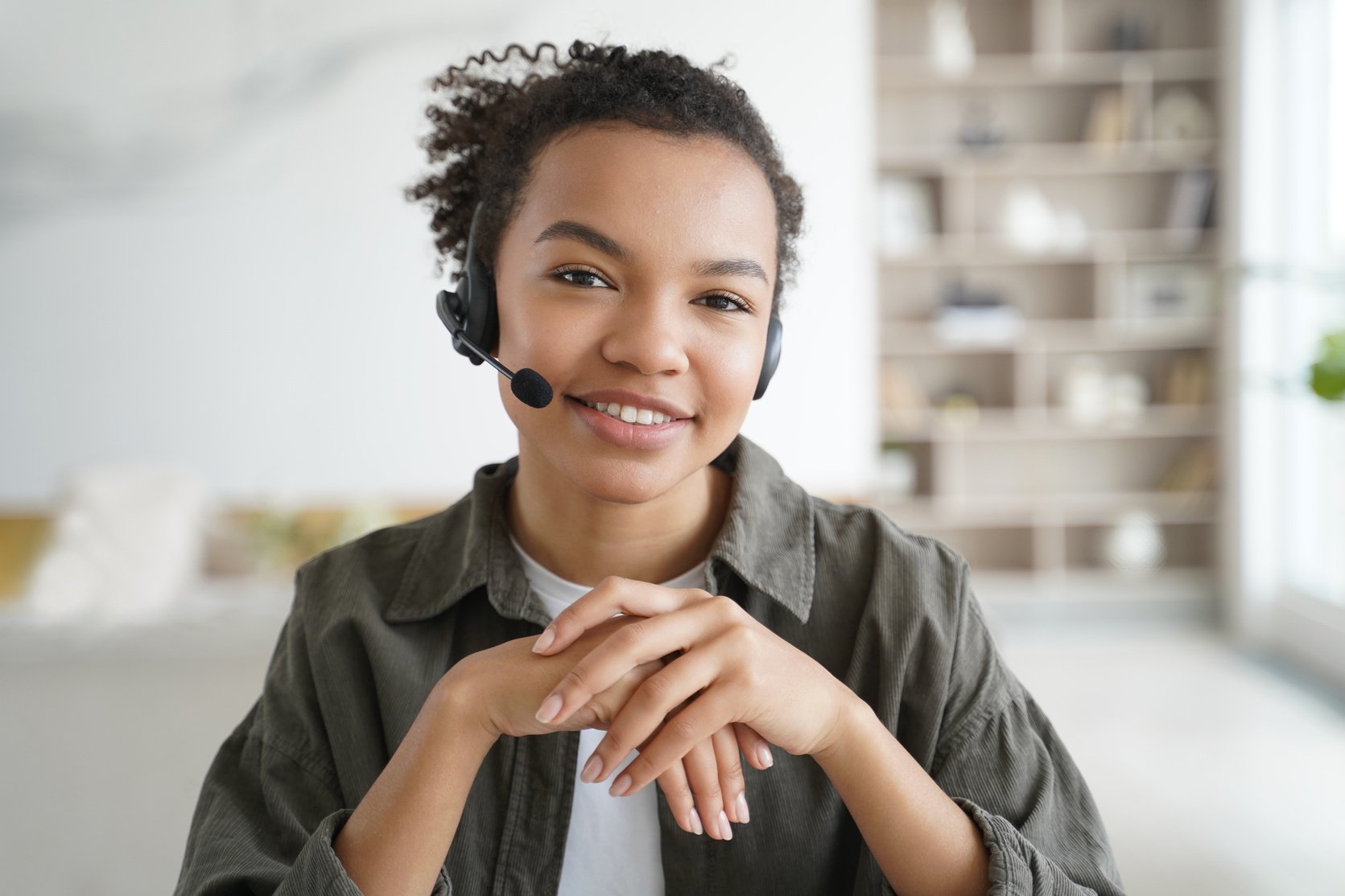 Virtual assistant. Young afro woman in headset is operator o