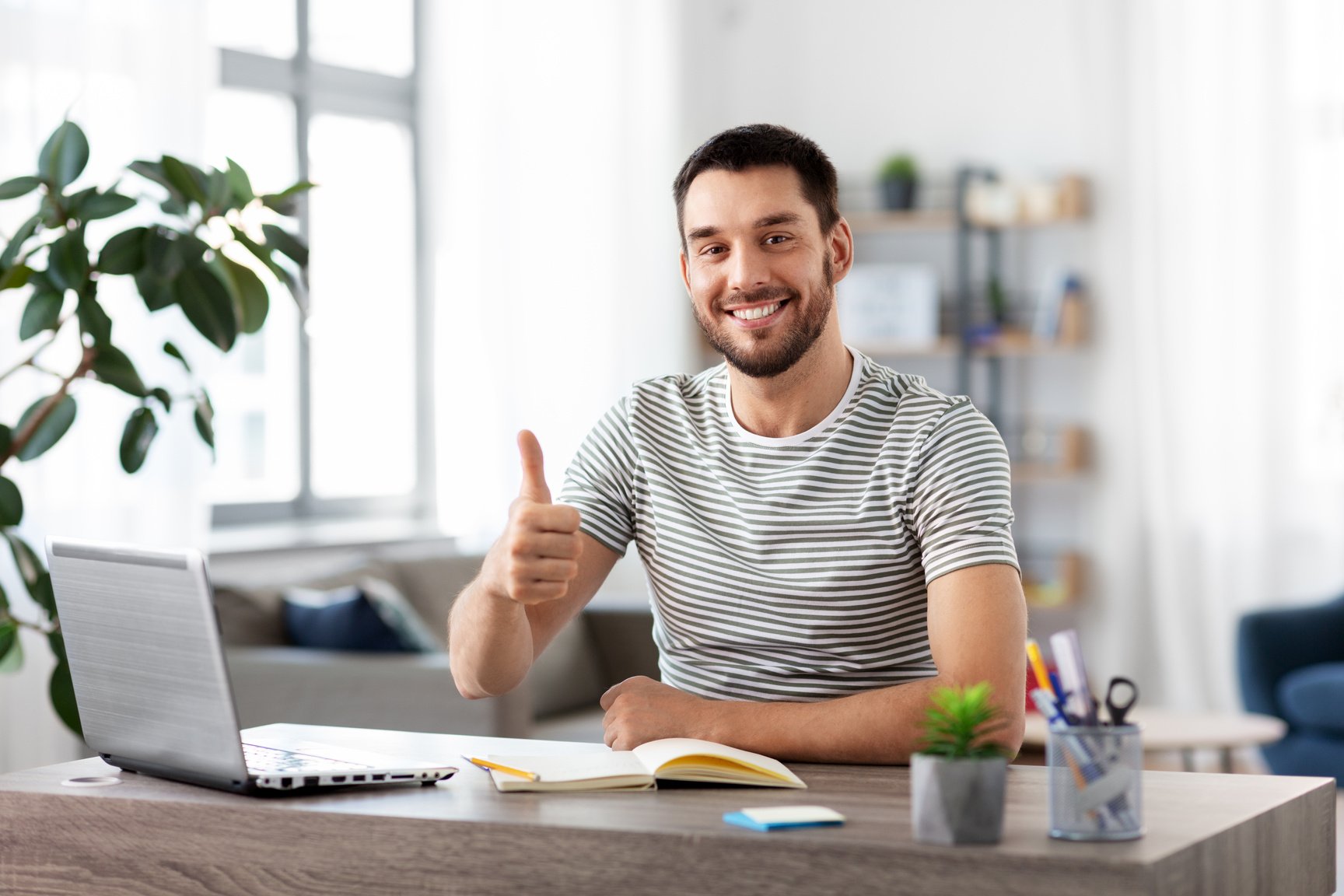 Happy Man with Laptop Working at Home Office